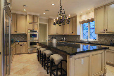 Inspiration for a large timeless u-shaped kitchen pantry remodel in Houston with a double-bowl sink, light wood cabinets, multicolored backsplash and an island