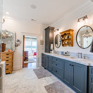 Large farmhouse master gray tile and marble tile marble floor, double-sink, shiplap wall, gray floor and coffered ceiling bathroom photo in Charlotte with recessed-panel cabinets, gray cabinets, an undermount sink, quartzite countertops, a hinged shower door, gray countertops, a built-in vanity, a one-piece toilet and gray walls