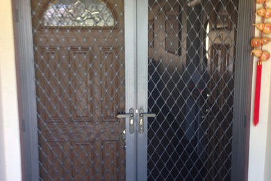 Entryway - entryway idea in Los Angeles with beige walls and a dark wood front door