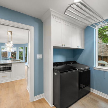 Laundry room entrance featuring a black front-load washer and dryer set.
