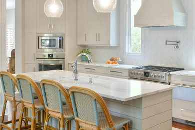 Example of a mid-sized transitional brown floor eat-in kitchen design in Atlanta with an undermount sink, flat-panel cabinets, white cabinets, quartz countertops, white backsplash, stainless steel appliances, an island and white countertops