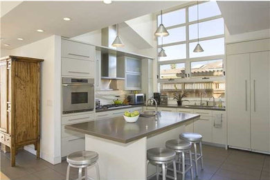 Example of a mid-sized minimalist l-shaped porcelain tile open concept kitchen design in San Diego with flat-panel cabinets, solid surface countertops, white backsplash, stone slab backsplash, stainless steel appliances, an island, a single-bowl sink and white cabinets