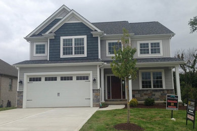 Blue two-story vinyl exterior home photo in Other
