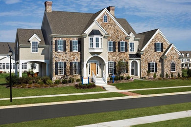 Example of a large classic beige two-story mixed siding gable roof design in Philadelphia