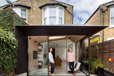 Photo of a contemporary sunroom in London.