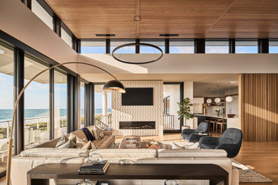 Living room - coastal light wood floor, wood ceiling and wood wall living room idea in Other with a tile fireplace, white walls and a wall-mounted tv