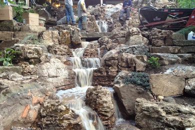 Photo of a transitional backyard water fountain landscape in New York with decking.