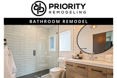 Mid-sized master white tile and ceramic tile marble floor, white floor and single-sink alcove shower photo in Los Angeles with medium tone wood cabinets, a one-piece toilet, white walls, an integrated sink, granite countertops, a hinged shower door, white countertops and a floating vanity