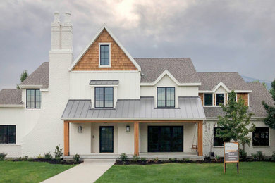 Example of a cottage white two-story exterior home design in Salt Lake City with a metal roof