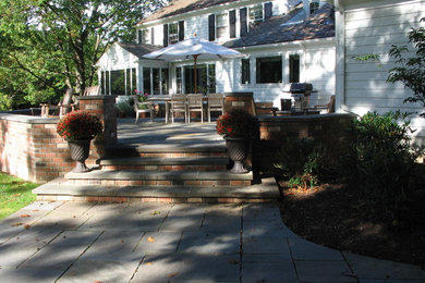Inspiration for a large timeless backyard stone patio remodel in Cleveland with no cover