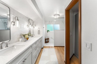 Inspiration for a mid-sized transitional master white tile and stone slab double-sink bathroom remodel in Seattle with shaker cabinets, beige cabinets, solid surface countertops, white countertops and a built-in vanity
