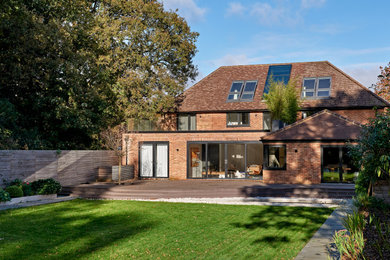 Inspiration for a large contemporary three-story brick house exterior remodel in London