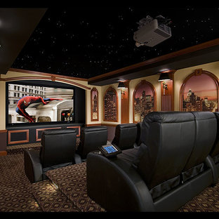 Inspiration for a large timeless enclosed carpeted and brown floor home theater remodel in New York with beige walls and a projector screen
