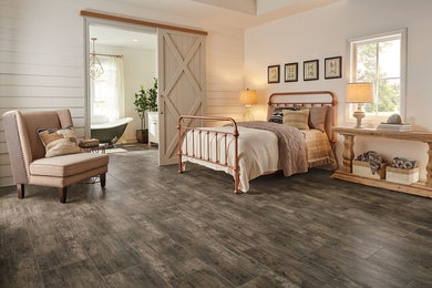 Inspiration for a large country master bedroom in Newark with white walls and porcelain floors.