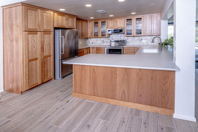 Inspiration for a timeless porcelain tile kitchen remodel in Phoenix with shaker cabinets, marble countertops and marble backsplash
