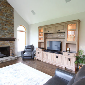 Two Toned Kitchen with White Island and Great Room Stacked Stone Fireplace
