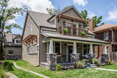 Example of a large transitional beige two-story wood exterior home design in Indianapolis with a shingle roof