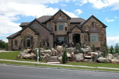 Example of a huge classic brown three-story mixed siding house exterior design in Salt Lake City with a hip roof and a shingle roof