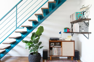 Example of a large eclectic wooden straight open and metal railing staircase design in New York