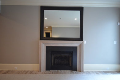 Inspiration for a small contemporary open concept porcelain tile and gray floor family room remodel in DC Metro with gray walls, a standard fireplace, a stone fireplace and a wall-mounted tv