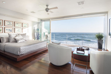 Inspiration for a beach style master bedroom in Los Angeles with white walls, no fireplace and dark hardwood floors.