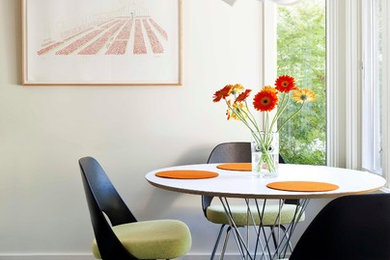 Design ideas for a modern dining room in Los Angeles with white walls and dark hardwood floors.