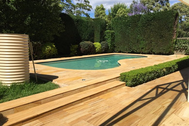 This is an example of a mid-sized mediterranean backyard custom-shaped lap pool in Sydney.