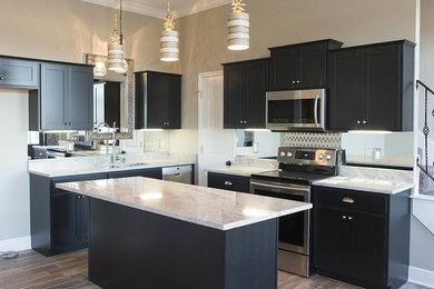Example of a mid-sized trendy l-shaped porcelain tile and brown floor open concept kitchen design in New Orleans with a double-bowl sink, shaker cabinets, dark wood cabinets, granite countertops, metallic backsplash, mirror backsplash, stainless steel appliances and an island