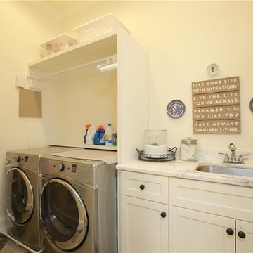Smaller upstairs laundry behind flush "hidden" door