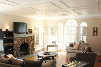 Inspiration for a mid-sized timeless open concept light wood floor family room remodel in Other with beige walls, a standard fireplace, a stone fireplace and a tv stand