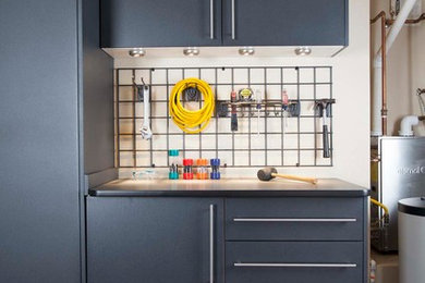 Inspiration for a large contemporary attached garage workshop remodel in Omaha
