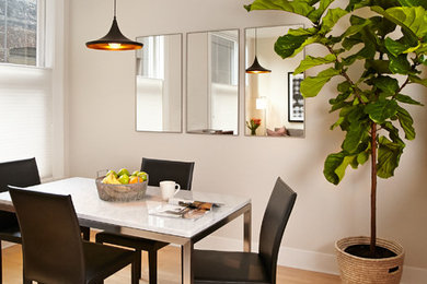 Kitchen/dining room combo - small contemporary light wood floor kitchen/dining room combo idea in San Francisco with white walls