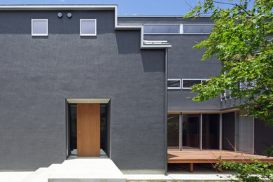 Large modern two-storey grey house exterior in Other.