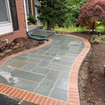Limestone walkway with brick ascent to match house