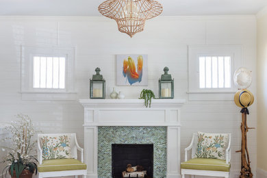 Inspiration for a small traditional formal living room in Jacksonville with white walls, medium hardwood floors, a standard fireplace and a tile fireplace surround.