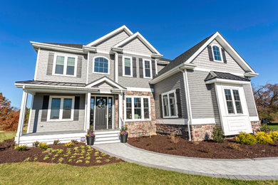 Large traditional gray two-story vinyl exterior home idea in Other with a shingle roof