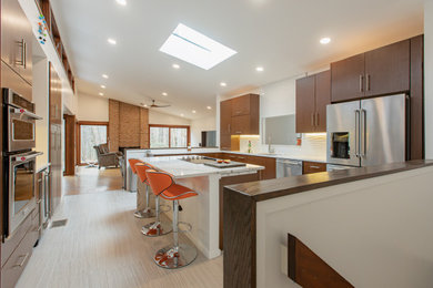 Kitchen pantry - large contemporary u-shaped porcelain tile and beige floor kitchen pantry idea in DC Metro with an undermount sink, flat-panel cabinets, medium tone wood cabinets, quartz countertops, white backsplash, ceramic backsplash, stainless steel appliances, an island and white countertops