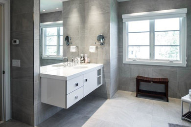 Bathroom - contemporary gray tile bathroom idea in San Diego with flat-panel cabinets, white cabinets and an undermount sink