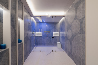 Example of a minimalist alcove shower design in New York with a hinged shower door
