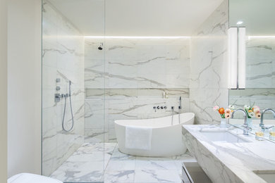 Inspiration for a contemporary master bathroom in New York with flat-panel cabinets, grey cabinets, a freestanding tub, an open shower, white walls, an undermount sink and an open shower.