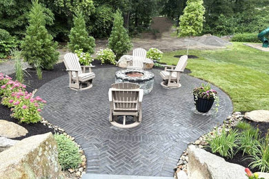 Mid-sized transitional backyard concrete paver patio photo in Providence with a fire pit