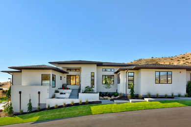 Inspiration for a contemporary gray two-story stucco flat roof remodel in Boise