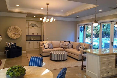 Living room - mid-sized transitional formal and open concept porcelain tile and beige floor living room idea in San Francisco with beige walls, a standard fireplace and a wall-mounted tv