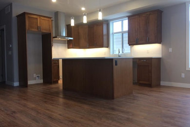 Mid-sized elegant l-shaped eat-in kitchen photo in Other with flat-panel cabinets, brown cabinets, quartz countertops, white backsplash and an island