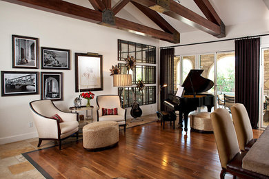 Large tuscan open concept medium tone wood floor, brown floor and exposed beam living room photo in Las Vegas with white walls