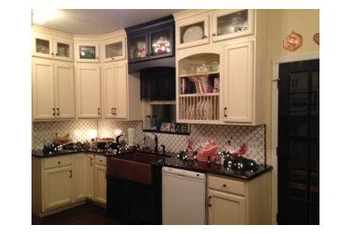 Transitional galley kitchen photo in Oklahoma City with a farmhouse sink, shaker cabinets, granite countertops, white backsplash, porcelain backsplash, white appliances and no island