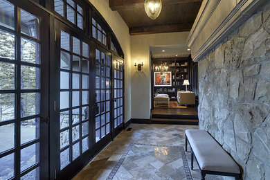 Large mountain style travertine floor hallway photo in Calgary with gray walls