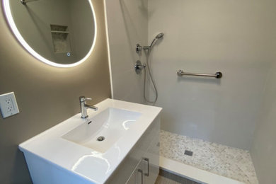 Inspiration for a modern master white tile and porcelain tile porcelain tile, beige floor and single-sink bathroom remodel in New York with flat-panel cabinets, white cabinets, beige walls, an integrated sink, white countertops and a floating vanity