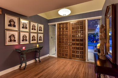 Entryway - huge 1950s entryway idea in Las Vegas with blue walls and a dark wood front door