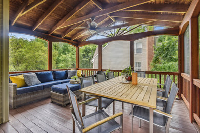 Mid-sized transitional screened-in and wood railing back porch photo in DC Metro with a roof extension